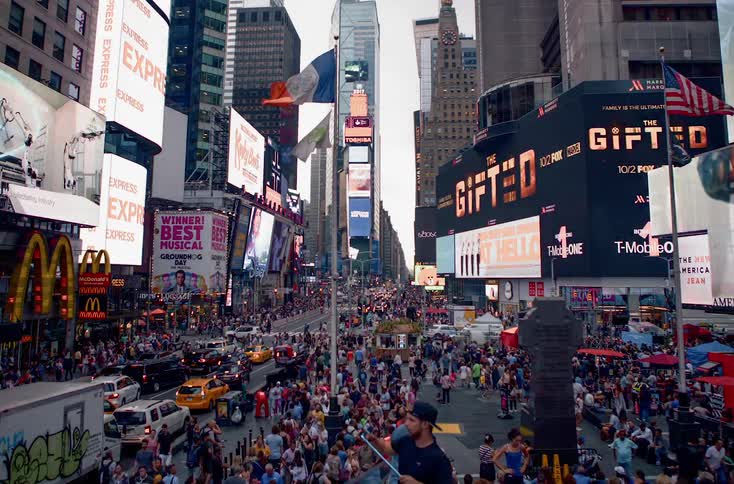 Time lapse of people and vehicles on a busy downtown street