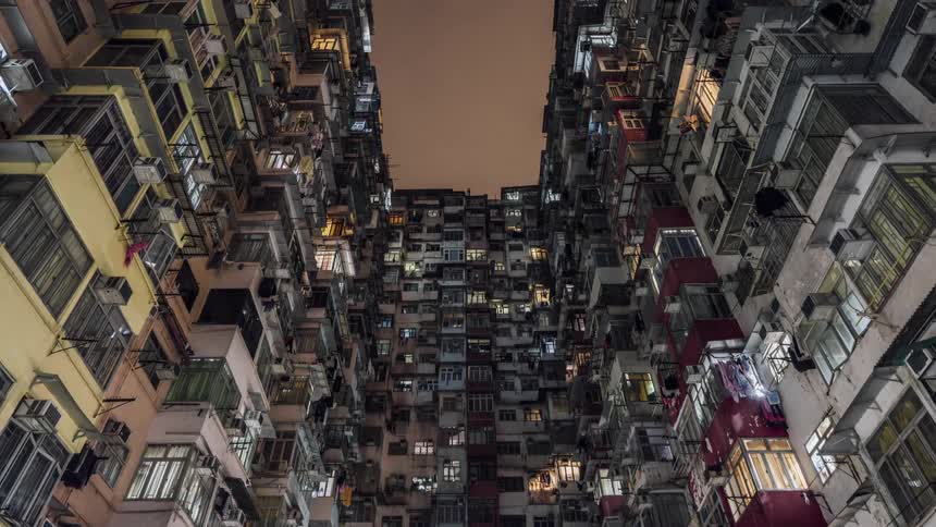 An upward view of monster building with five interconnected buildings in quarry bay hong kong