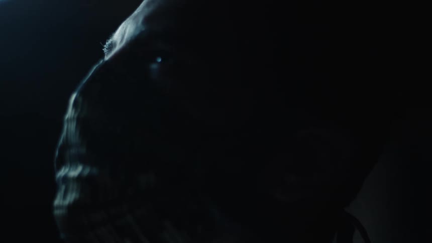 A man with a face mask looking off into the distance