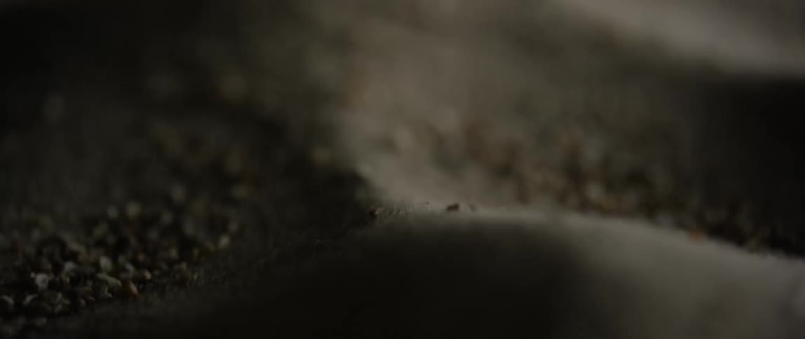 Black sand falling in piles
