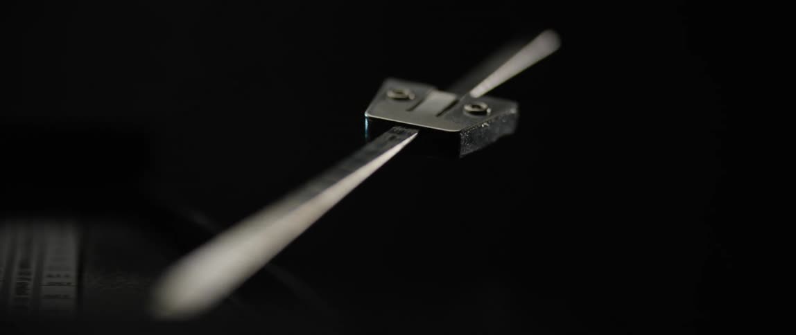 A metronome swings back and forth