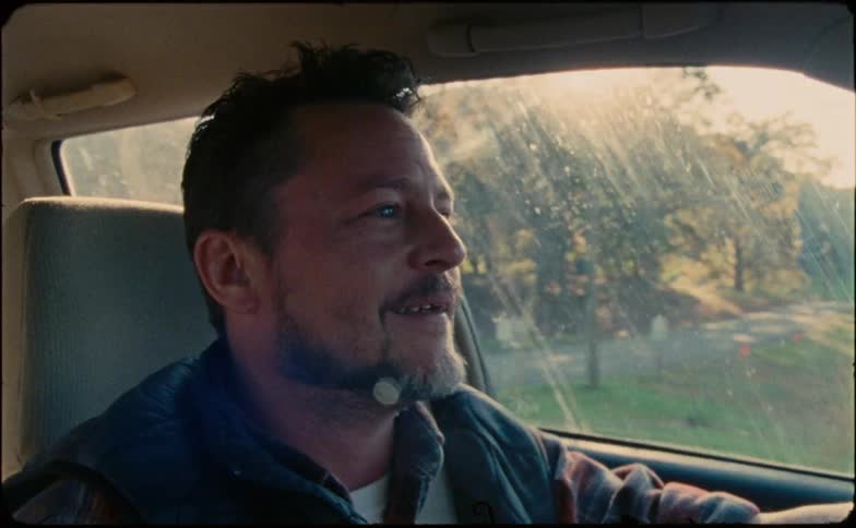 Man talks to the passenger while driving a car