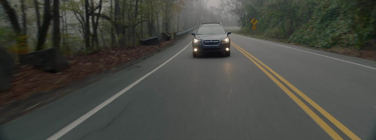 An suv being driven on a mountain road