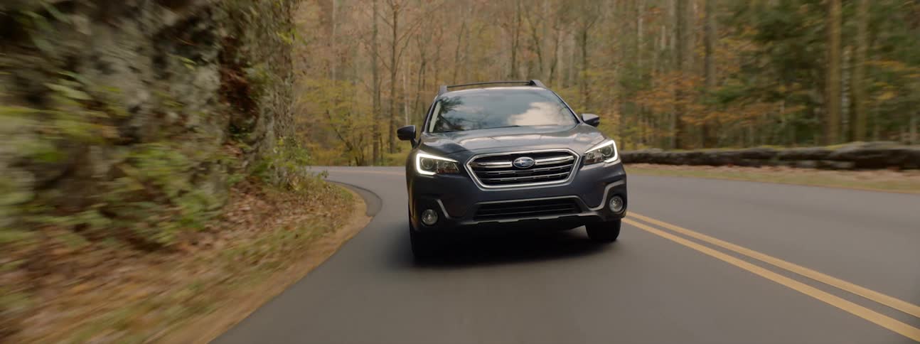An estate car driven on a mountain road