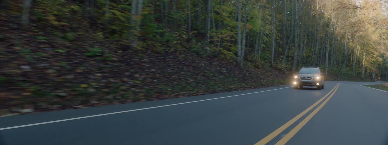 An estate car driven on a mountain road