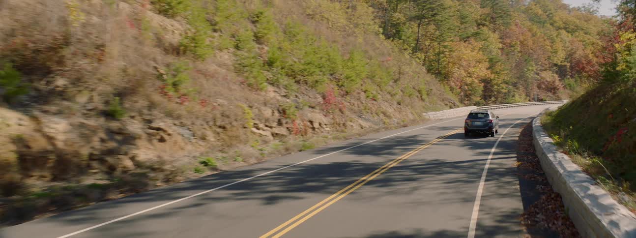 An estate car driven on a mountain road