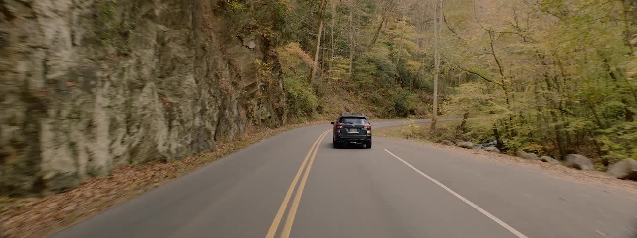An suv being driven on a mountain road