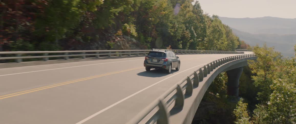 An suv being driven on a mountain road