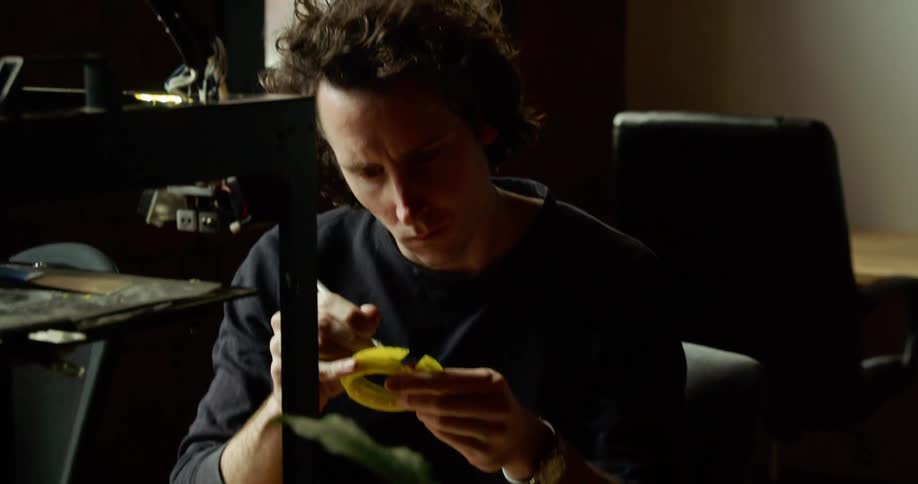 Man works with plastic near 3d printer