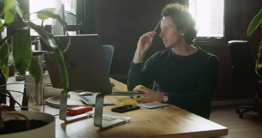 A man thinks at his desk