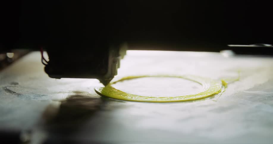 Yellow plastic coming out of a 3d printer