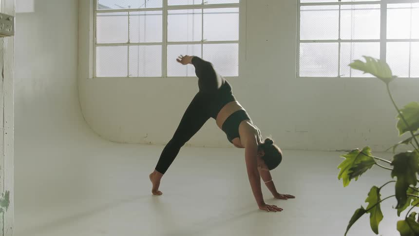 A woman does yoga indoors