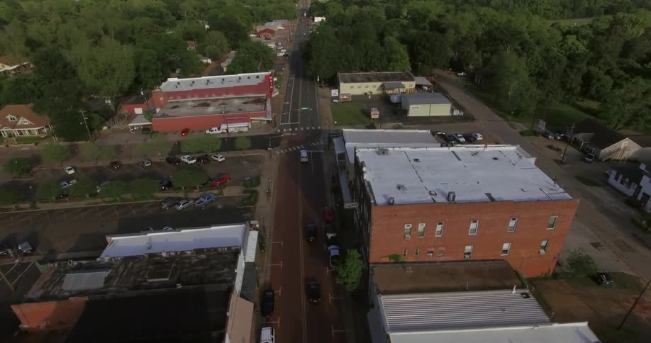 Cars drive down the road in a city