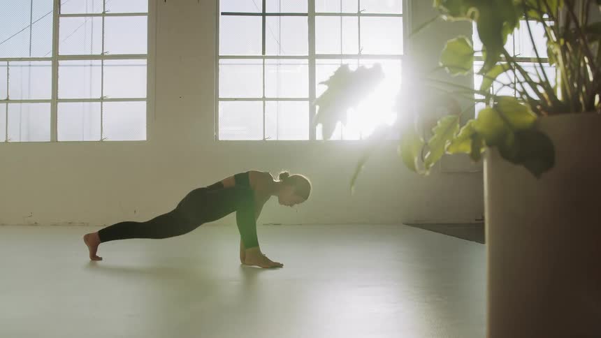 A woman stretches her body multiple different ways in yoga