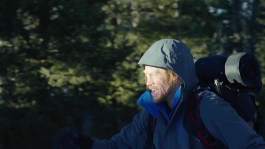 A man hiking in the forest in snow