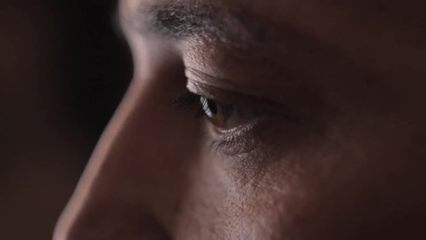 A mans face looking off into the distance