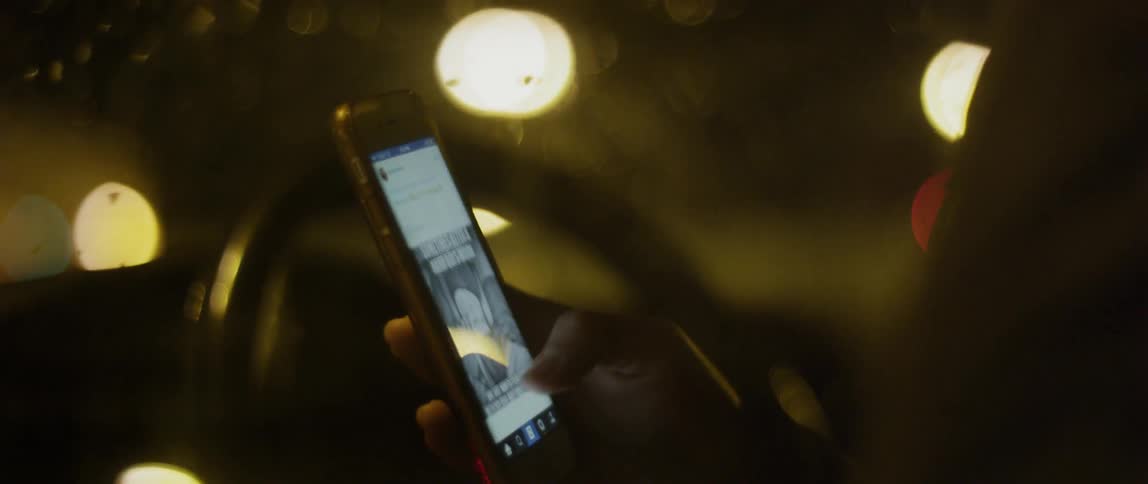 A woman scrolling through a website on her phone