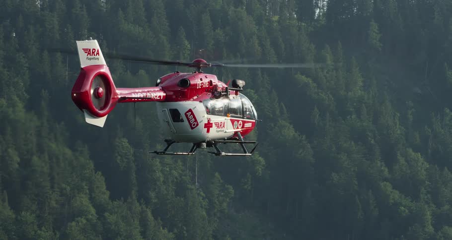 Helicopter flies over the forest in the air