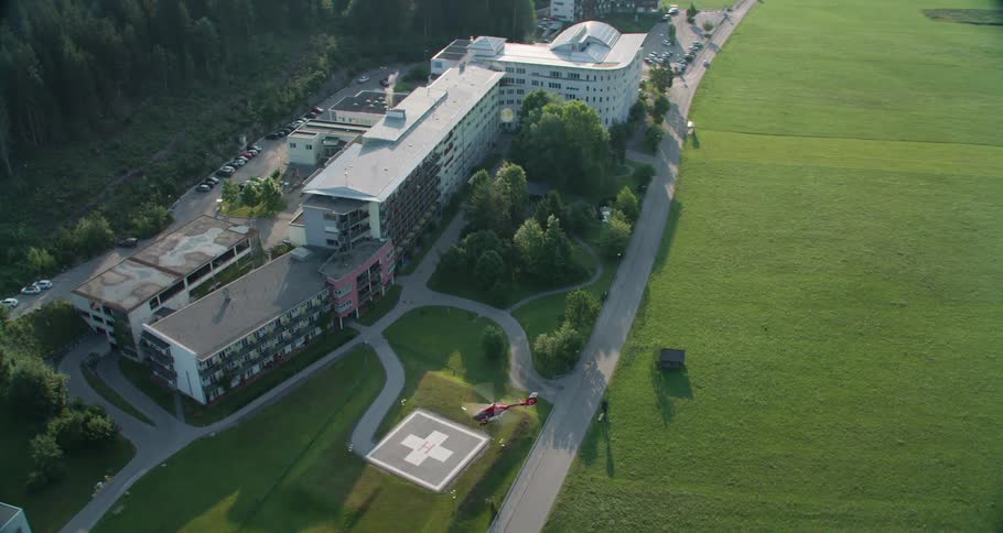 A medical helicopter prepares to land at a hospital