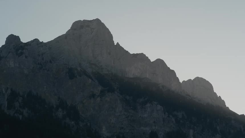A mountain with the sky in the background