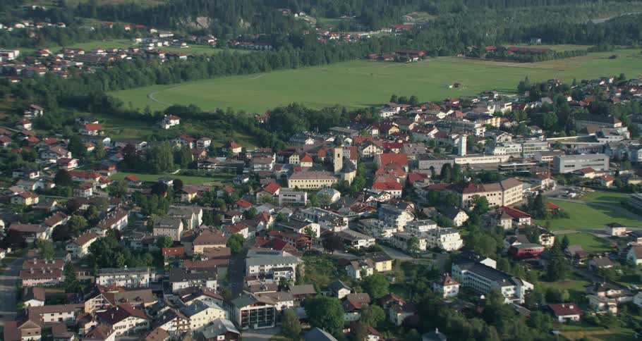 Many homes sit next to the trees on a hill