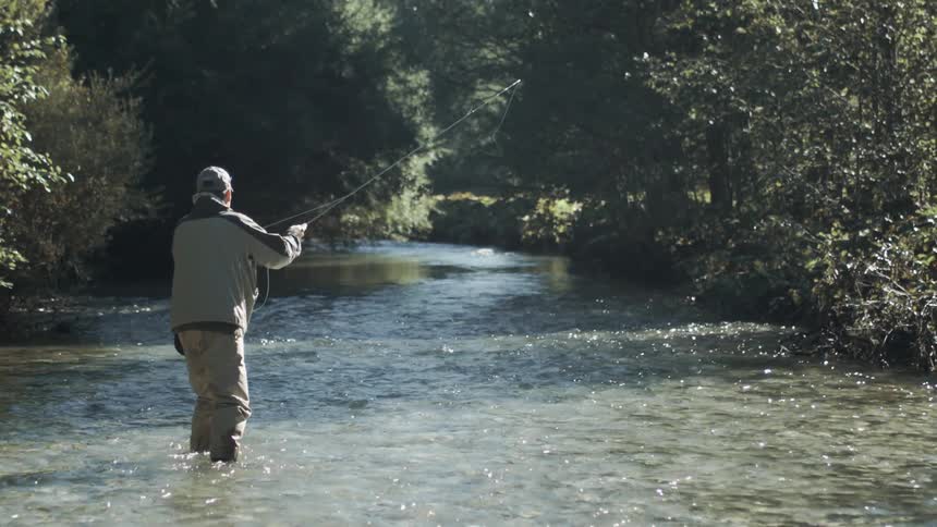 Man casts a fishing line in the river