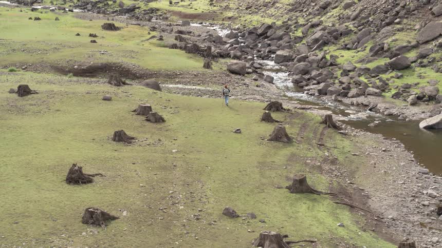 A man is hiking through a landscape area