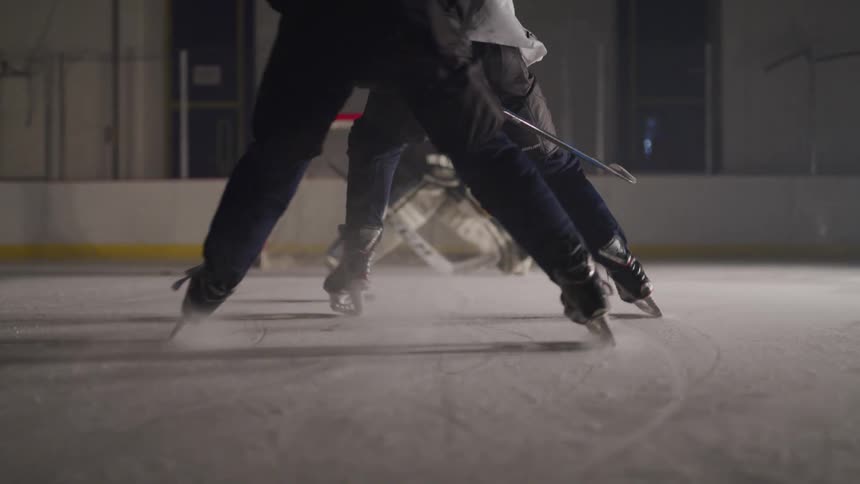 A goalie drops to his knees to save a goal on the ice
