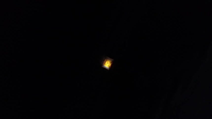 A glowing rectangle that looks like a tent with a light inside