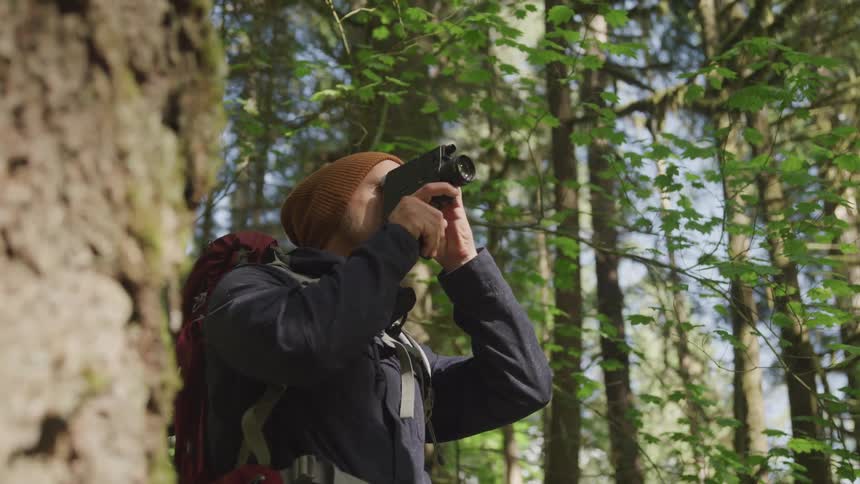 Man makes a video in the forest