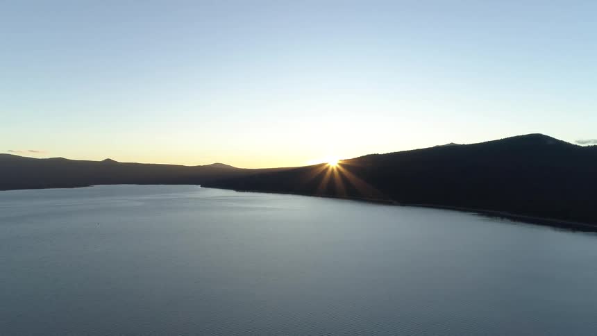 The sun setting over a lake