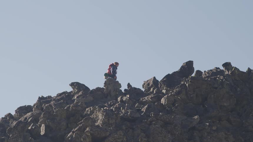 Hiker climbing a rock mountain
