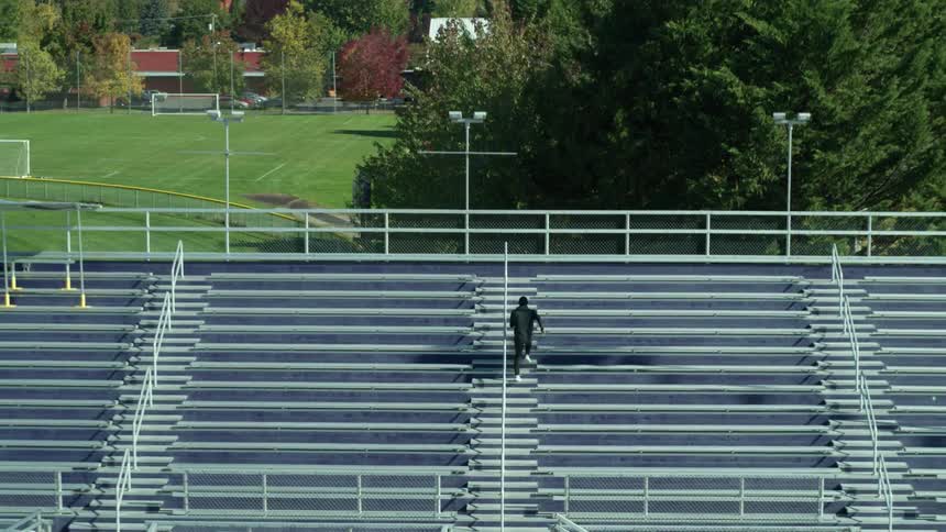 A man runs up stadium steps