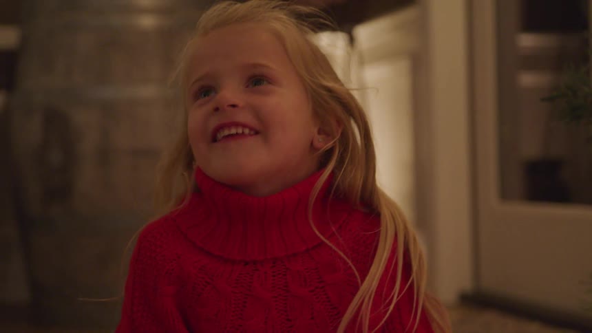 Blonde little girl feels and shows great happiness about the christmas gift
