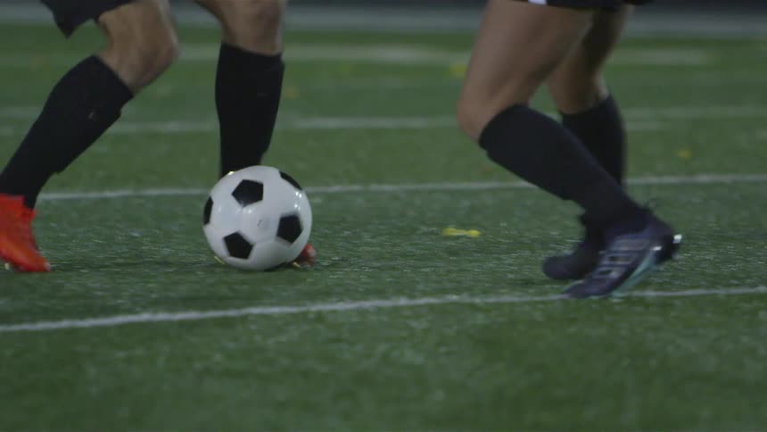 Two men playing soccer