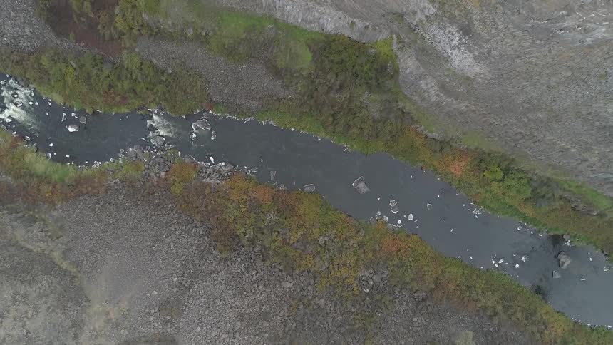 Boats float in the narrow river