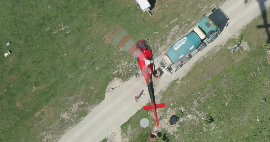 Birds eye view of a man motioning a helicopter