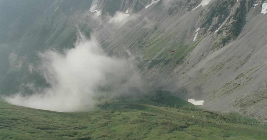 Helicopter flying close to the mountains
