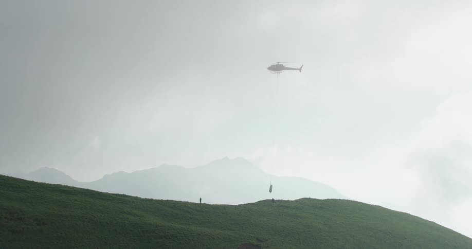 The helicopter pulls toward the people