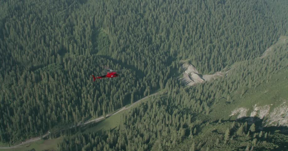A helicopter flies over the land