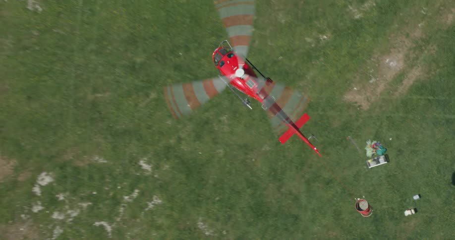 A helicopter carries a bucket