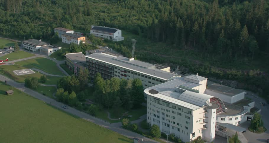 Building complex is separated by forest from town