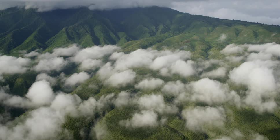 Clouds hover over a mountainous area