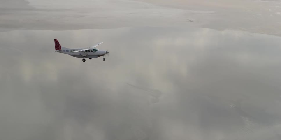 A plain is flying high on a cloudy day