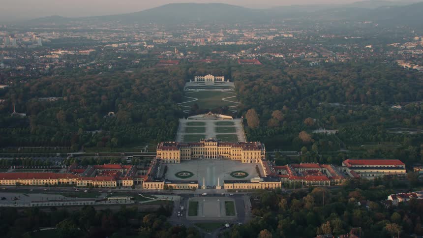 An aerial view of buildings and park trees in a city