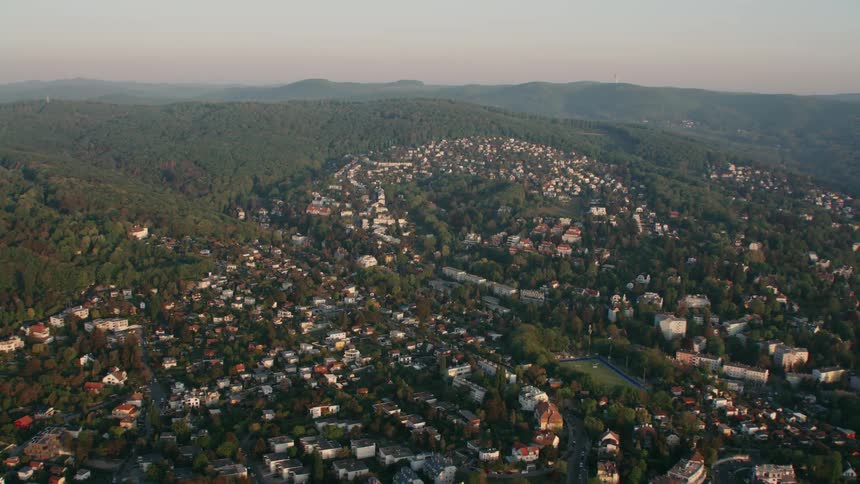 The homes and buildings sit on the green hills