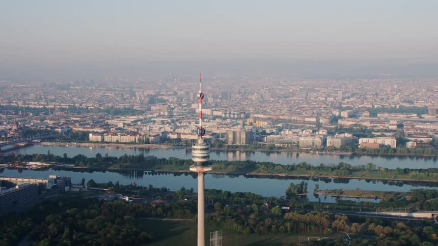 An aerial view of a downtown skyline surrounded by water is displayed