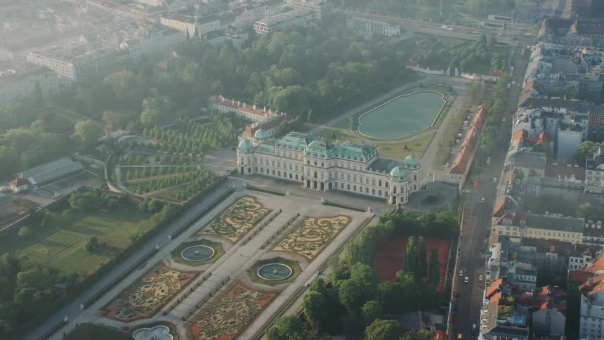 A very large building surrounded by buildings in a city