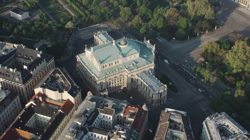 Aerial view of white cathedral building with light blue roof in densely populated urban area