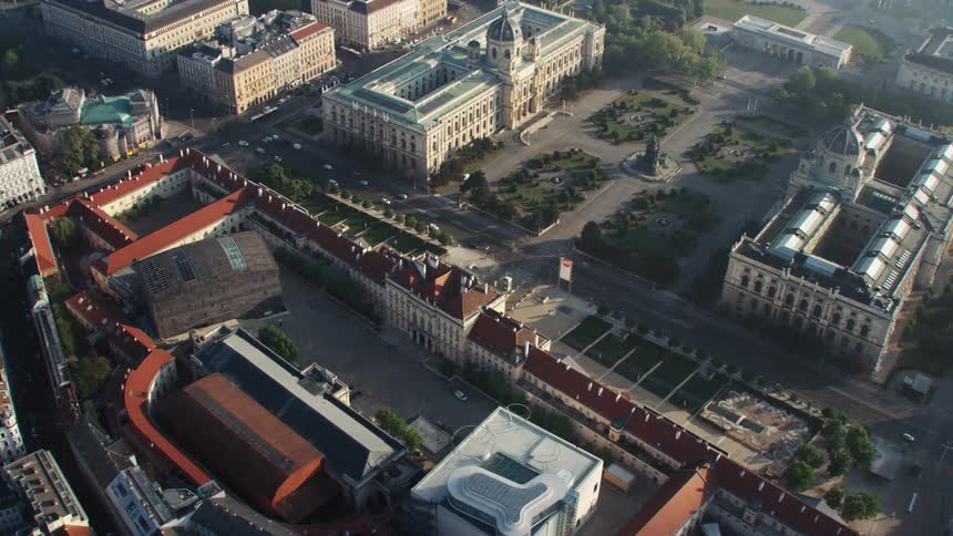 The vehicles travel down the avenue in the city